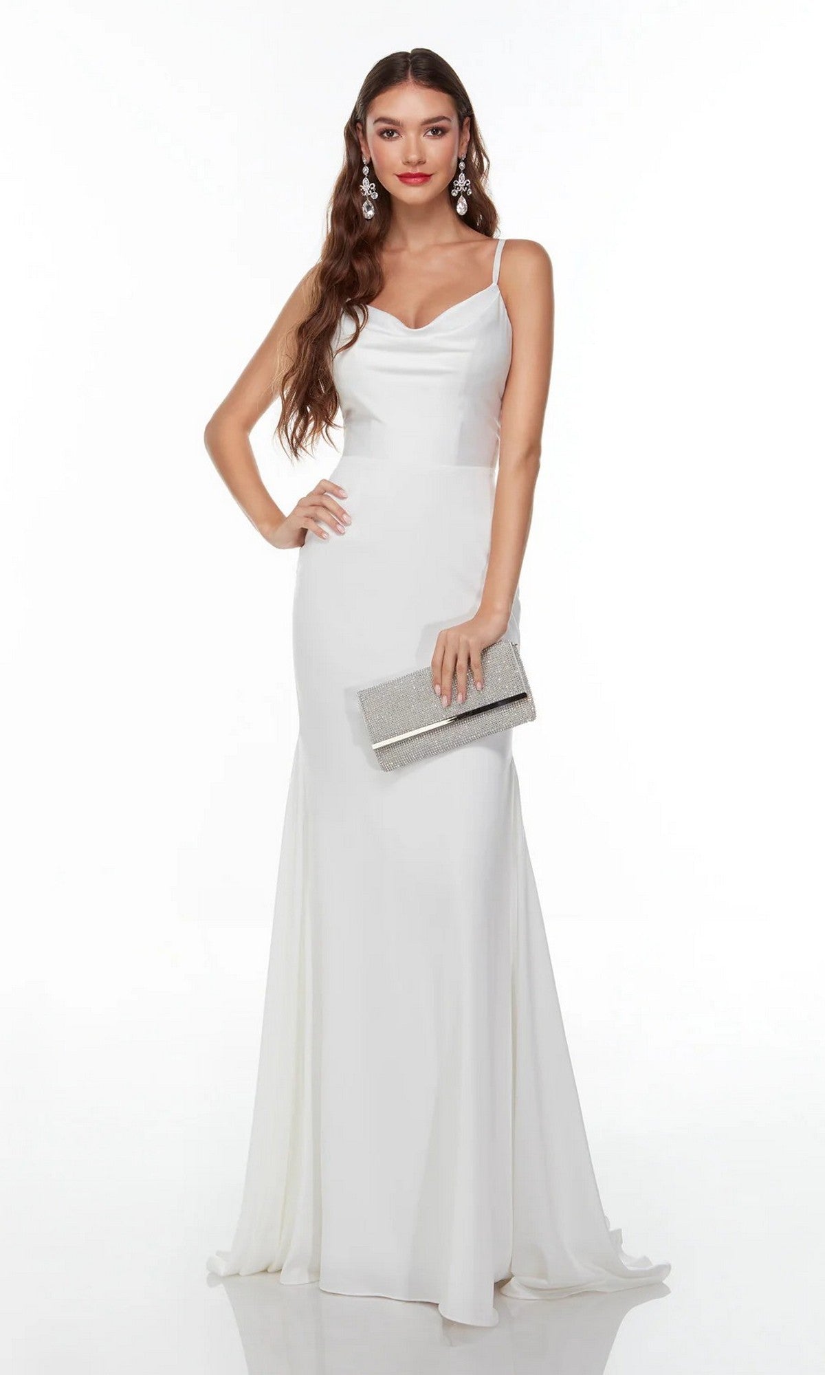 A woman in the Alyce 7051 long white dress with spaghetti straps, holding a silver clutch and wearing dangling earrings, stands against a plain white background.